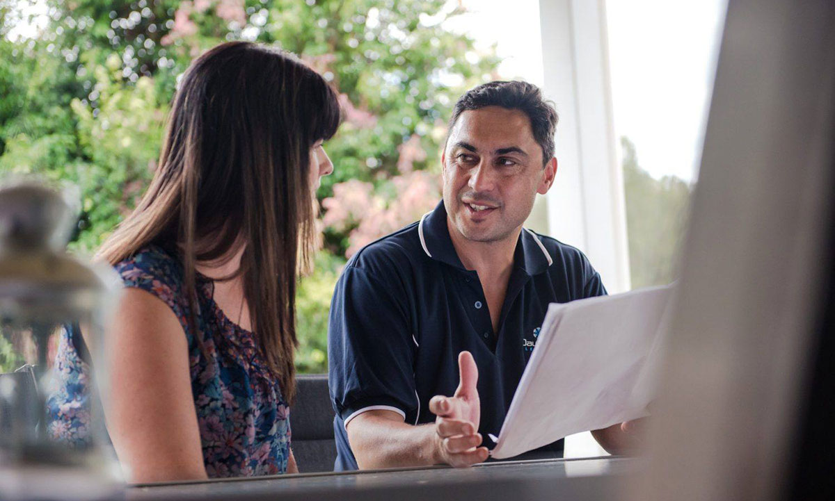 Electrician discussing electrical plans with a customer | Dawson Electric