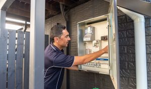 Electrician working on outdoor home switchboard | Dawson Electric
