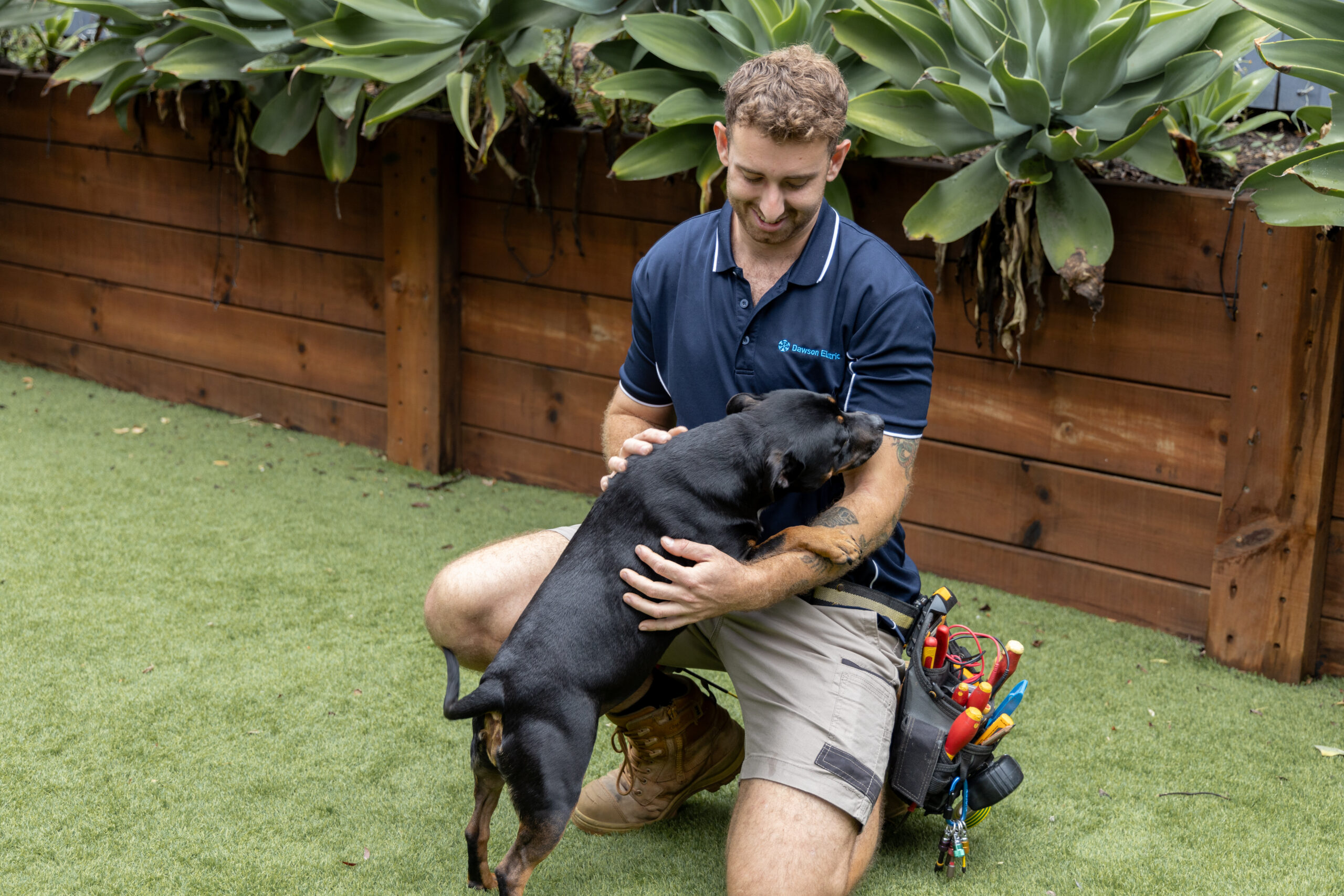 Dawson-101 Dawson Electric electrician patting a dog